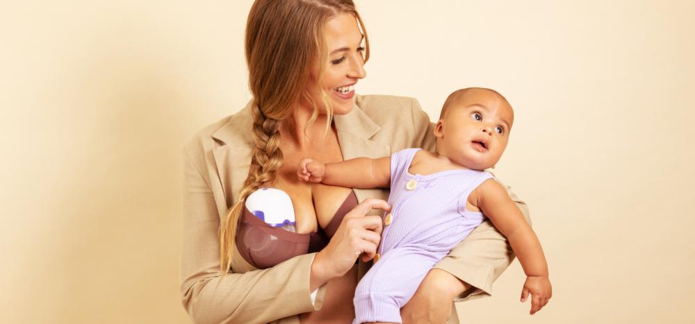 woman holding baby and pumping